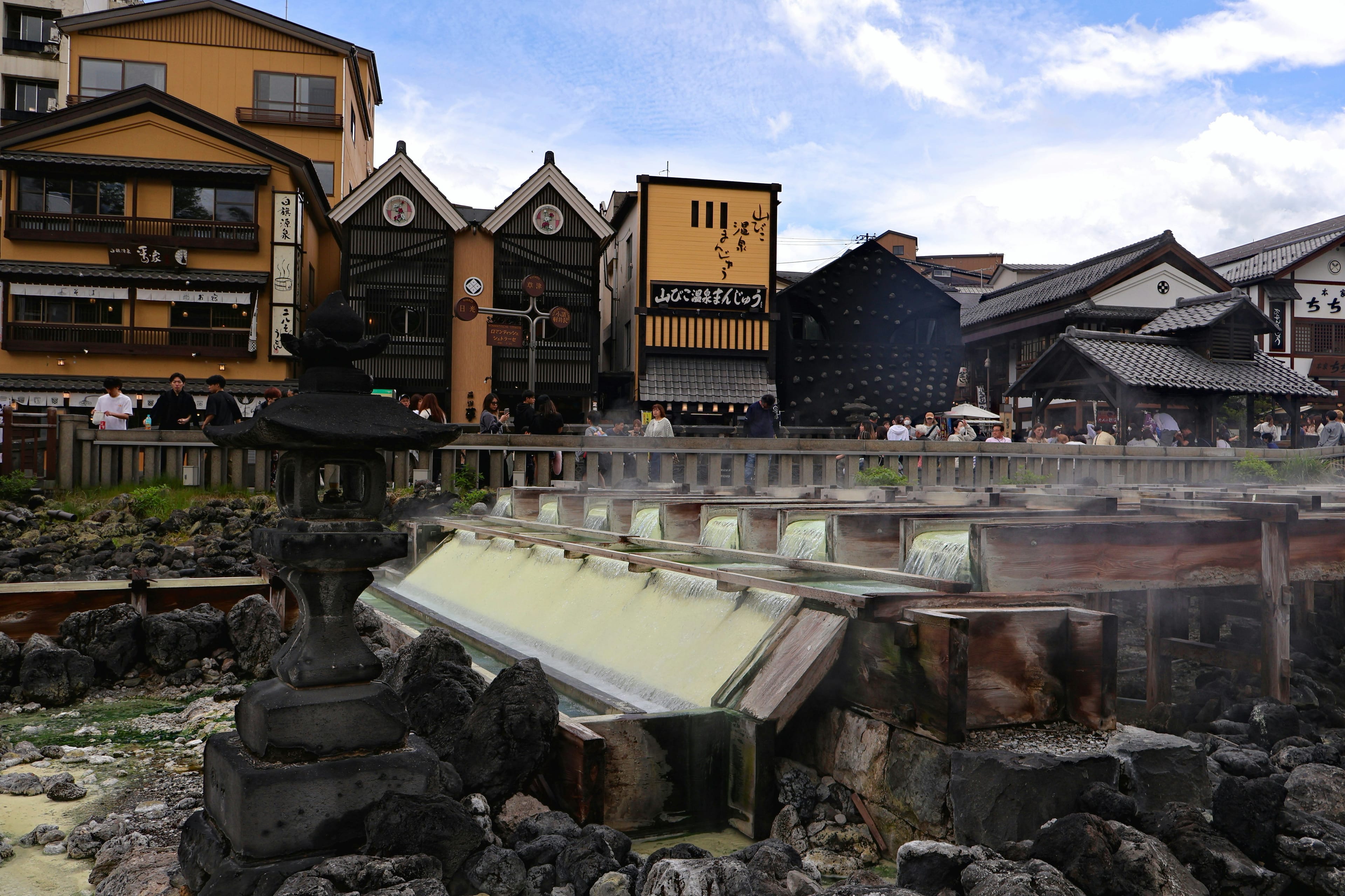 Steaming hot springs with traditional Japanese buildings